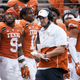 In this Friday, Nov. 27, 2020, file photo, Texas head coach Tom Herman, center, walks on the sideline during the second half of an NCAA college football game against Iowa State in Austin, Texas.